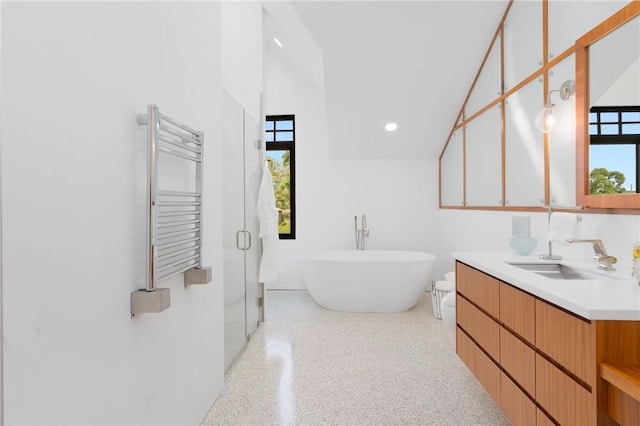 82 Nonquit Ln, Tiverton, RI 02878 - bathroom featuring radiator, speckle patterned floor, vanity, high vaulted ceiling, and a soaking tub