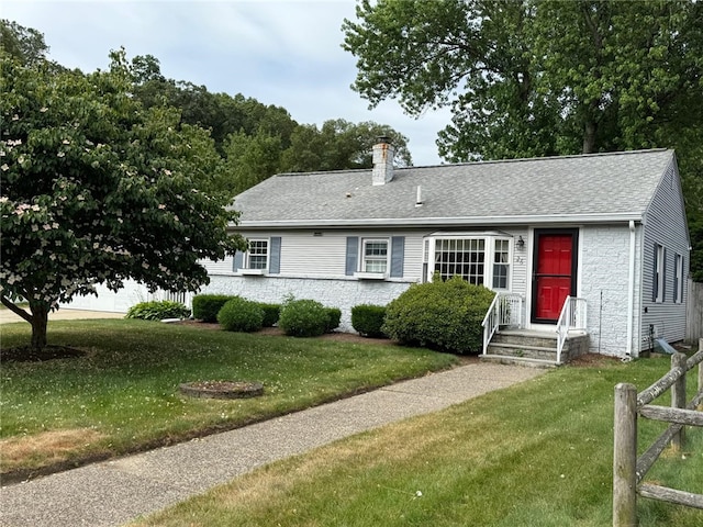 26 Flora Ave, Woonsocket, RI 02895 - view of front of home with a chimney, a front yard, roof with shingles, and stone siding
