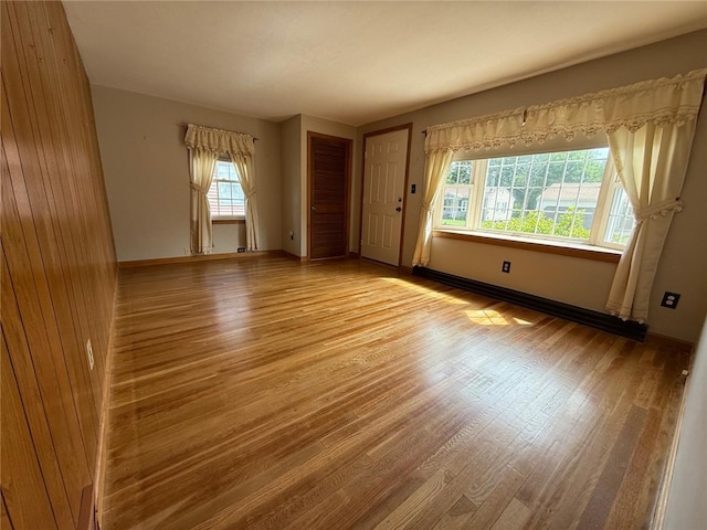 26 Flora Ave, Woonsocket, RI 02895 - empty room with healthy amount of natural light and wood finished floors