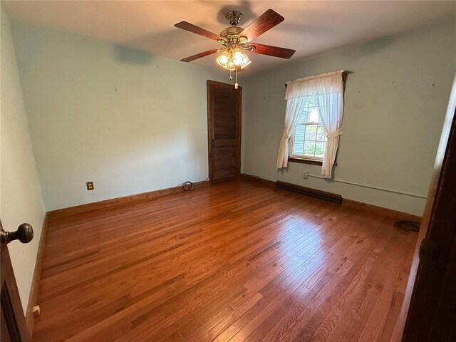 26 Flora Ave, Woonsocket, RI 02895 - empty room with wood finished floors and a ceiling fan