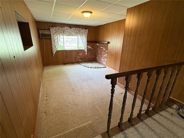 26 Flora Ave, Woonsocket, RI 02895 - carpeted spare room featuring wooden walls, an AC wall unit, and a drop ceiling