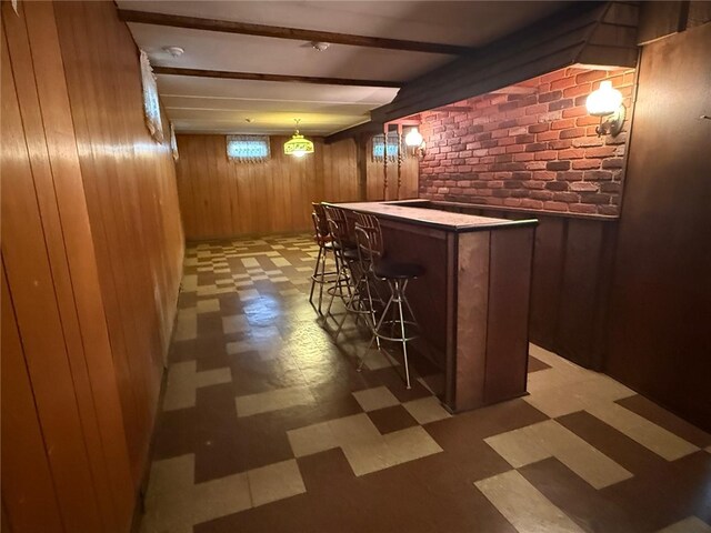 26 Flora Ave, Woonsocket, RI 02895 - indoor dry bar with light floors, wooden walls, beam ceiling, brick wall, and decorative light fixtures