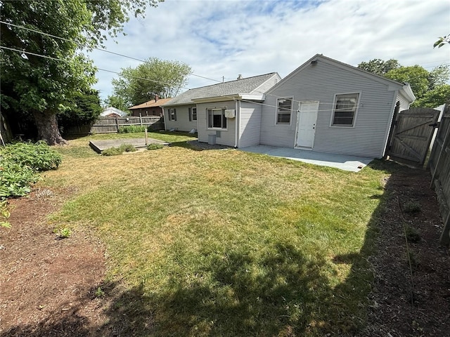 26 Flora Ave, Woonsocket, RI 02895 - rear view of house with a patio area, a fenced backyard, and a gate