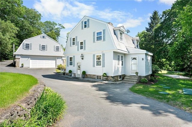 355 Scott Rd, Cumberland, RI 02864 - dutch colonial featuring a gambrel roof, a garage, a front lawn, and an outdoor structure