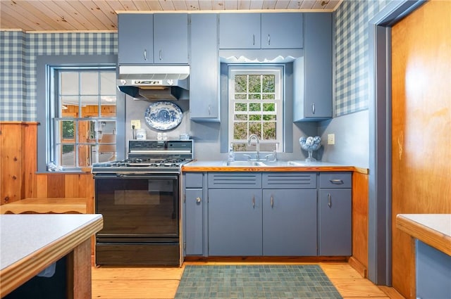 355 Scott Rd, Cumberland, RI 02864 - kitchen with wallpapered walls, black range with gas stovetop, wall chimney exhaust hood, wood ceiling, and light wood-style floors