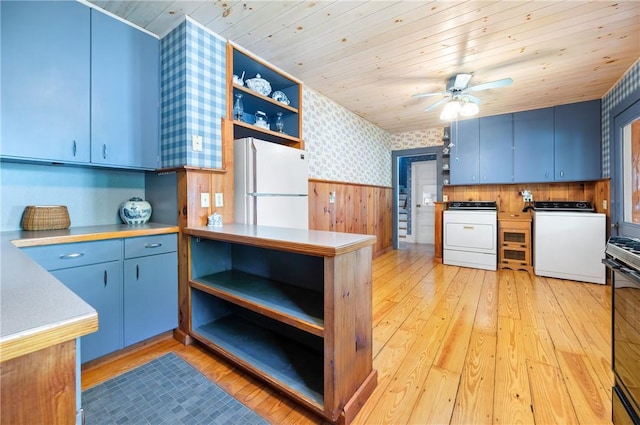 355 Scott Rd, Cumberland, RI 02864 - kitchen with open shelves, washer / clothes dryer, freestanding refrigerator, wallpapered walls, and blue cabinetry