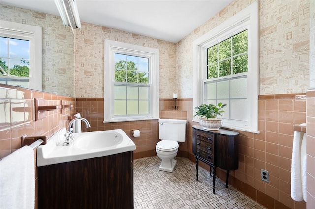 355 Scott Rd, Cumberland, RI 02864 - bathroom with tile walls, vanity, a wainscoted wall, tile patterned floors, and wallpapered walls