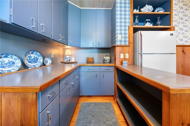 355 Scott Rd, Cumberland, RI 02864 - kitchen featuring freestanding refrigerator, a peninsula, light wood-type flooring, light countertops, and blue cabinets