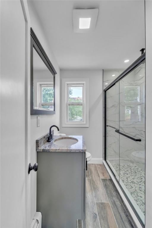 60 Hazael St, Providence, RI 02908 - bathroom featuring wood finished floors, a marble finish shower, and vanity