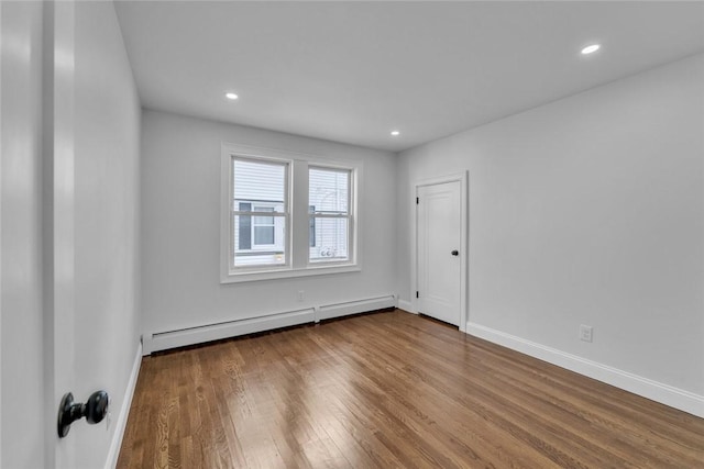 60 Hazael St, Providence, RI 02908 - spare room featuring a baseboard radiator, wood finished floors, and recessed lighting