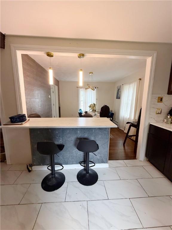 26 Westmore St, Providence, RI 02910 - kitchen featuring healthy amount of natural light, light countertops, decorative light fixtures, and a kitchen breakfast bar
