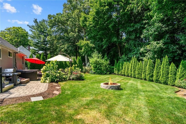 32 Spencer Rd, Smithfield, RI 02828 - view of grassy yard with a hot tub, a fire pit, and a patio area