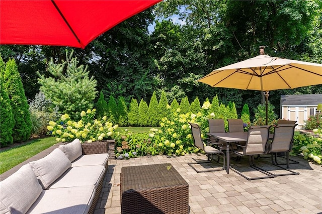 32 Spencer Rd, Smithfield, RI 02828 - view of patio / terrace featuring outdoor lounge area, outdoor dining space, a storage shed, and view of wooded area