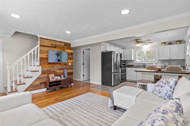32 Spencer Rd, Smithfield, RI 02828 - living area with stairway, recessed lighting, crown molding, light wood-style floors, and wooden walls