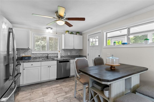 32 Spencer Rd, Smithfield, RI 02828 - kitchen featuring stainless steel appliances, tasteful backsplash, a ceiling fan, white cabinetry, and crown molding