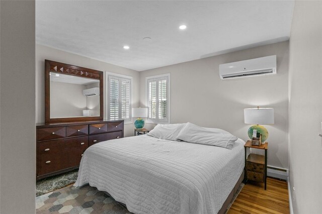 32 Spencer Rd, Smithfield, RI 02828 - bedroom with a wall unit AC, a baseboard heating unit, recessed lighting, and wood finished floors