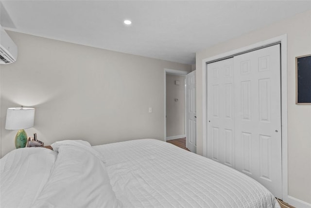 32 Spencer Rd, Smithfield, RI 02828 - bedroom featuring a closet, a wall mounted air conditioner, recessed lighting, and wood finished floors