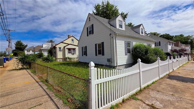 61 Terrace Ave, Pawtucket, RI 02860 - view of property exterior with a fenced front yard and roof with shingles