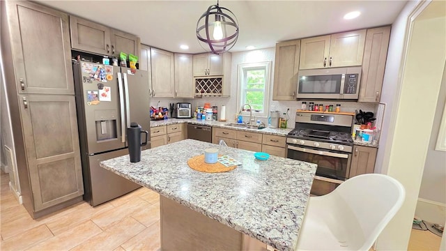 61 Terrace Ave, Pawtucket, RI 02860 - kitchen with stainless steel appliances, backsplash, light stone countertops, a center island, and recessed lighting