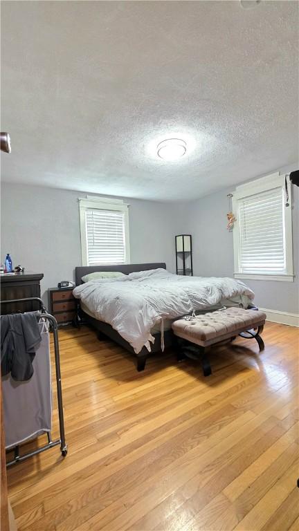 61 Terrace Ave, Pawtucket, RI 02860 - bedroom featuring light wood-style floors and a textured ceiling