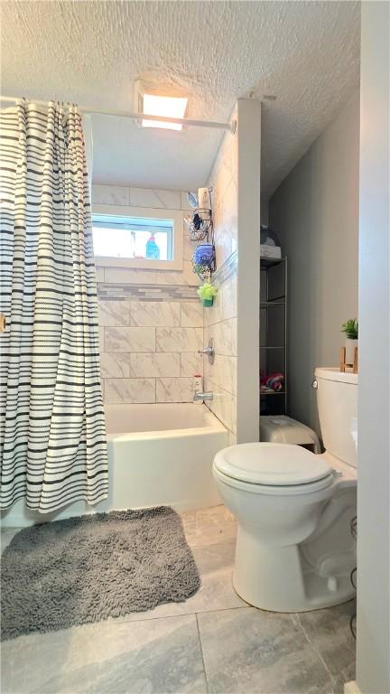 61 Terrace Ave, Pawtucket, RI 02860 - full bath featuring shower / bathtub combination with curtain and a textured ceiling
