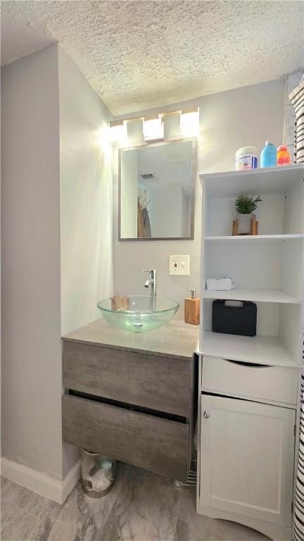 61 Terrace Ave, Pawtucket, RI 02860 - bathroom with a textured ceiling and vanity