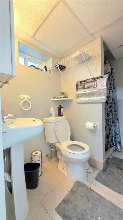 61 Terrace Ave, Pawtucket, RI 02860 - bathroom with tile patterned floors and a shower with shower curtain
