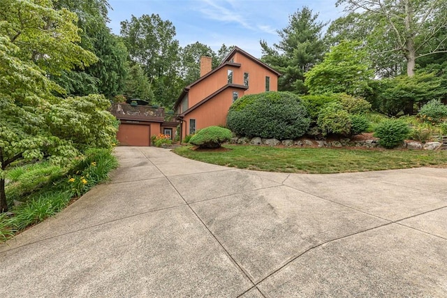4 Wilbur Rd, Lincoln, RI 02865 - view of property exterior featuring a chimney and concrete driveway