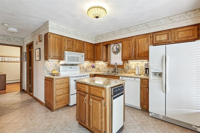 4 Wilbur Rd, Lincoln, RI 02865 - kitchen with white appliances, baseboard heating, light tile patterned floors, a center island, and brown cabinetry