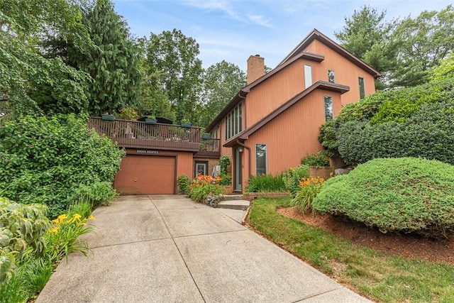 4 Wilbur Rd, Lincoln, RI 02865 - view of front facade featuring a chimney, driveway, and an attached garage