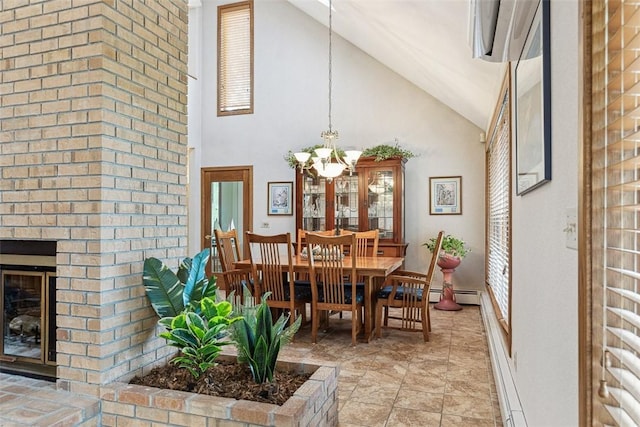4 Wilbur Rd, Lincoln, RI 02865 - dining area featuring high vaulted ceiling, a chandelier, a baseboard heating unit, and a fireplace