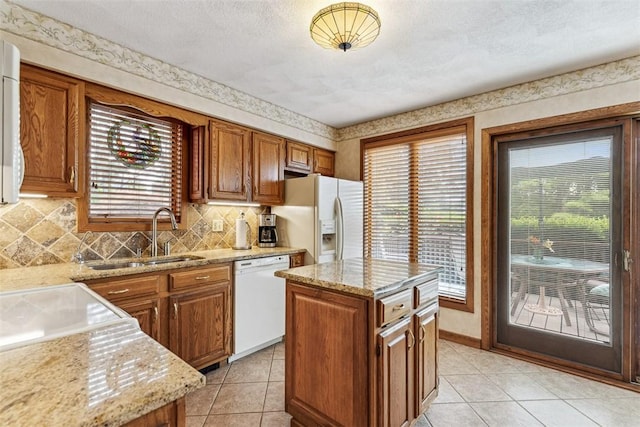 4 Wilbur Rd, Lincoln, RI 02865 - kitchen featuring white appliances, brown cabinetry, light stone counters, and tasteful backsplash