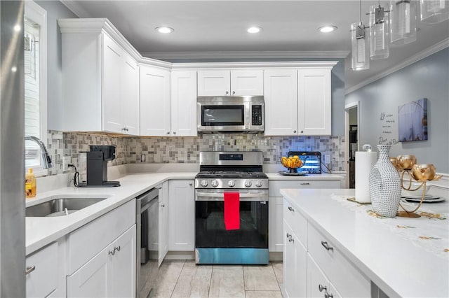 43 Amsterdam St, Providence, RI 02909 - kitchen featuring stainless steel appliances, crown molding, light countertops, white cabinets, and tasteful backsplash