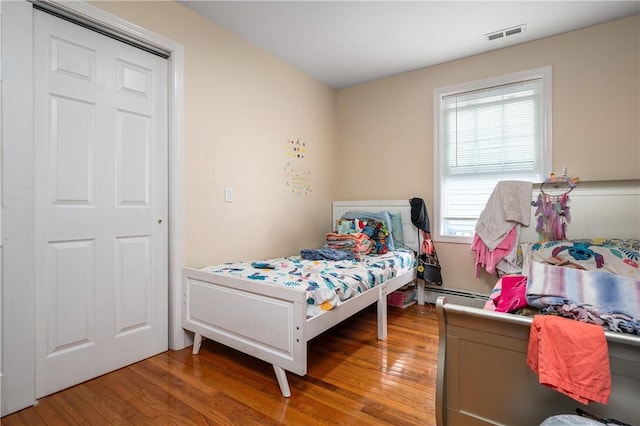 43 Amsterdam St, Providence, RI 02909 - bedroom with light wood-style flooring and a baseboard heating unit