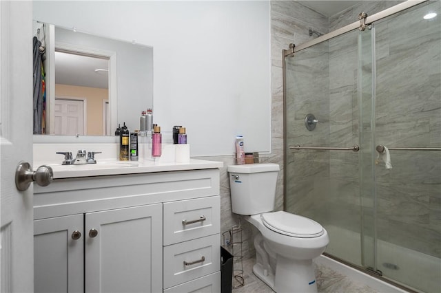 43 Amsterdam St, Providence, RI 02909 - full bath with vanity, a shower stall, tile walls, and marble look tiles