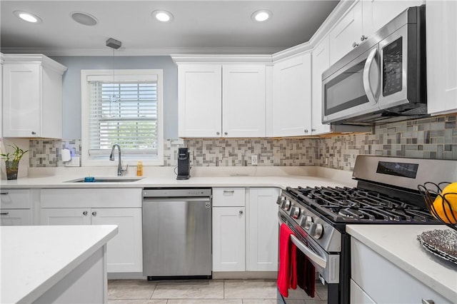 43 Amsterdam St, Providence, RI 02909 - kitchen featuring appliances with stainless steel finishes, crown molding, white cabinets, light countertops, and backsplash
