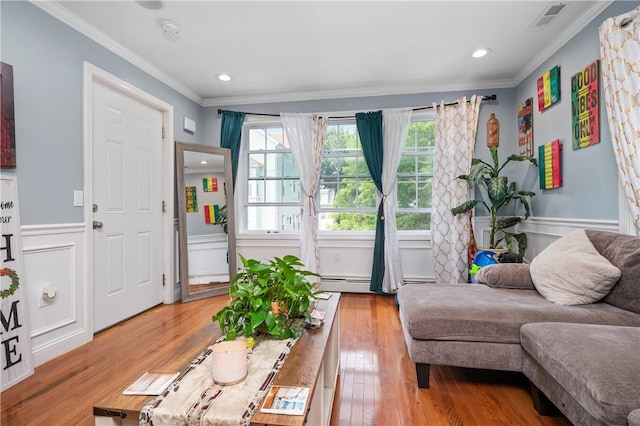 43 Amsterdam St, Providence, RI 02909 - living room featuring crown molding, wainscoting, light wood-style floors, recessed lighting, and a baseboard radiator