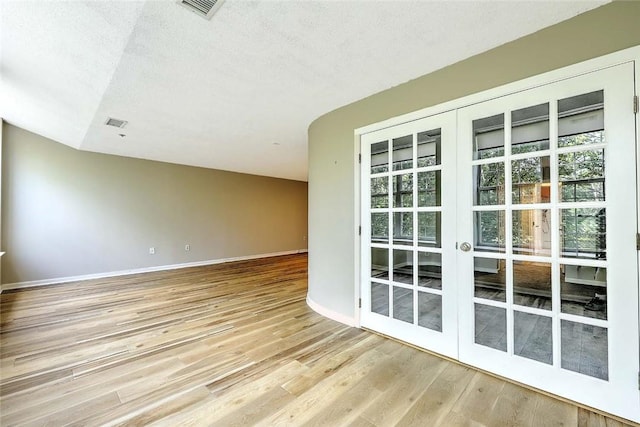 2 School St Unit 334, Lincoln, RI 02802 - spare room with french doors, light wood finished floors, and a textured ceiling