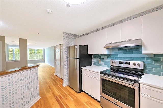 2 School St Unit 334, Lincoln, RI 02802 - kitchen with stainless steel appliances, under cabinet range hood, light countertops, light wood-type flooring, and white cabinetry
