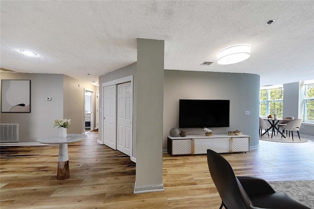 2 School St Unit 334, Lincoln, RI 02802 - living area with a textured ceiling and light wood finished floors
