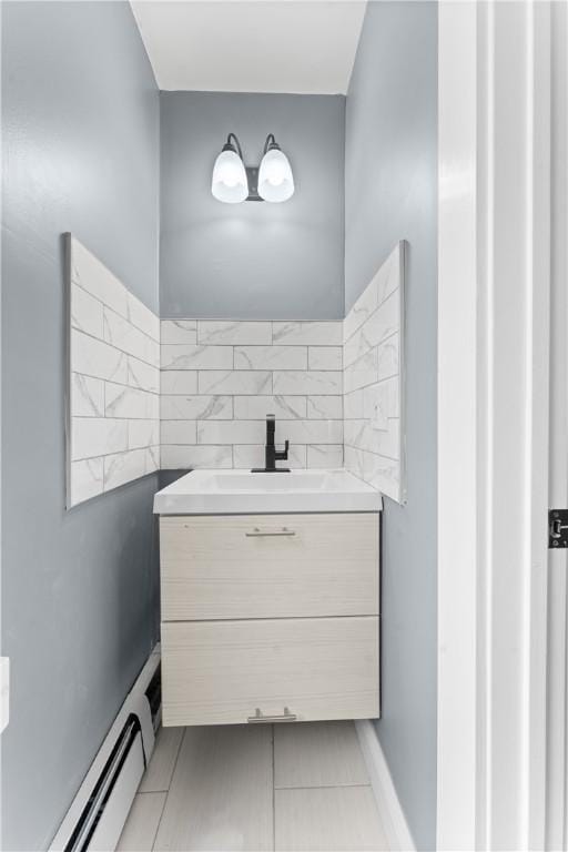 31 Stadden St, Providence, RI 02907 - bathroom with a baseboard radiator, vanity, and tile patterned flooring