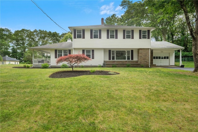 15 Bestwick Trl, Coventry, RI 02816 - colonial-style house with a garage, a chimney, a front lawn, and driveway