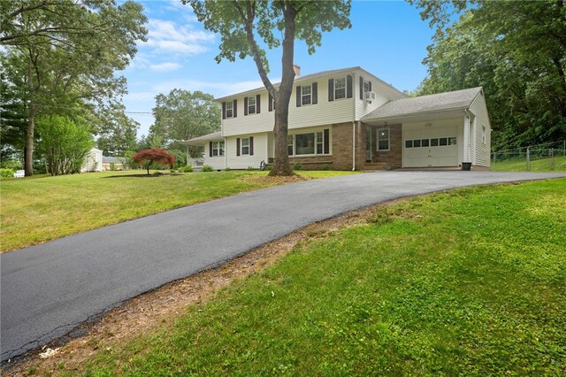 15 Bestwick Trl, Coventry, RI 02816 - colonial-style house featuring an attached garage, driveway, and a chimney