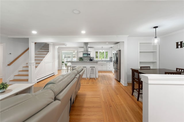 15 Bestwick Trl, Coventry, RI 02816 - living room featuring a baseboard heating unit, crown molding, stairway, recessed lighting, and light wood-style floors