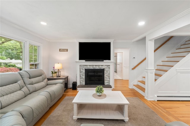 15 Bestwick Trl, Coventry, RI 02816 - living area featuring a baseboard radiator, light wood-style flooring, crown molding, stairway, and recessed lighting