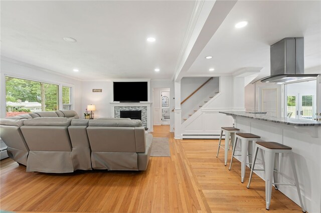 15 Bestwick Trl, Coventry, RI 02816 - living area featuring crown molding, light wood-type flooring, stairway, recessed lighting, and a fireplace