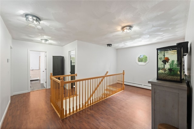 15 Bestwick Trl, Coventry, RI 02816 - corridor with an upstairs landing, baseboard heating, and wood finished floors