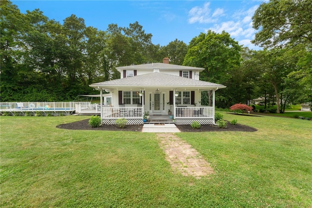 15 Bestwick Trl, Coventry, RI 02816 - view of front of home featuring a porch, an outdoor pool, a front lawn, a chimney, and view of scattered trees