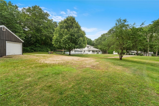 15 Bestwick Trl, Coventry, RI 02816 - view of grassy yard featuring a detached garage and an outbuilding