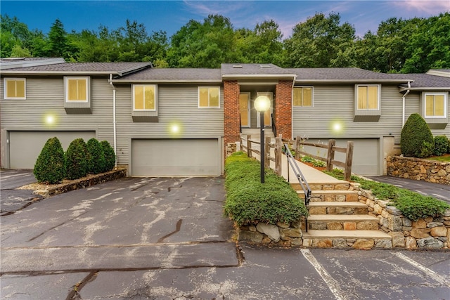125 Smith Ave Unit 4C, Smithfield, RI 02828 - view of front of home with a garage, driveway, and view of scattered trees